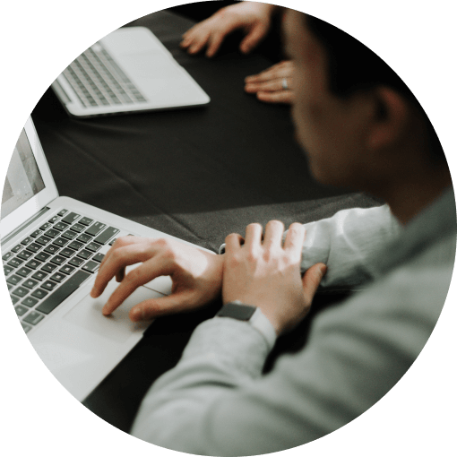 A man sitting down by the table with his laptop in a Marketing Agency in Chicago